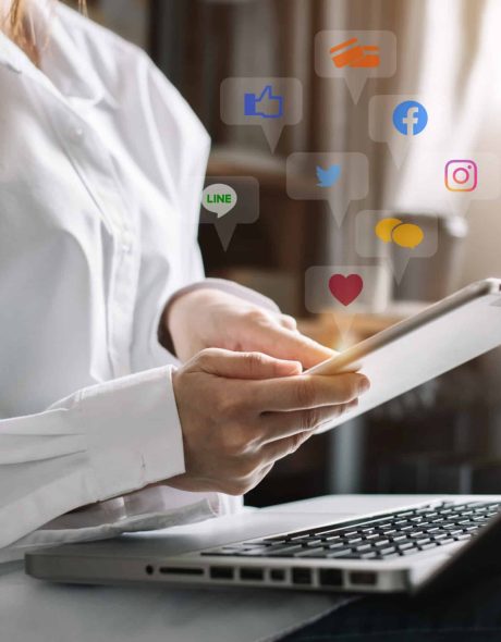Social media and Marketing virtual icons screen of business women typing keyboard with laptop computer and tablet at home.